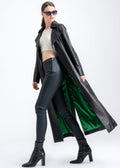 Model wearing a long black lambskin leather trench coat with emerald green lining, designed by Lebeni.