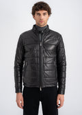 Man wearing a black lamb leather quilted jacket with stand collar, front zipper and side zip pockets by Lebeni.