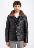 Man wearing a black lambskin quilted jacket with genuine fur collar, center zip with button placket, and multi pockets by Lebeni.