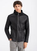Model wearing a men’s black shearling leather jacket with stand collar and front zipper by Lebeni.