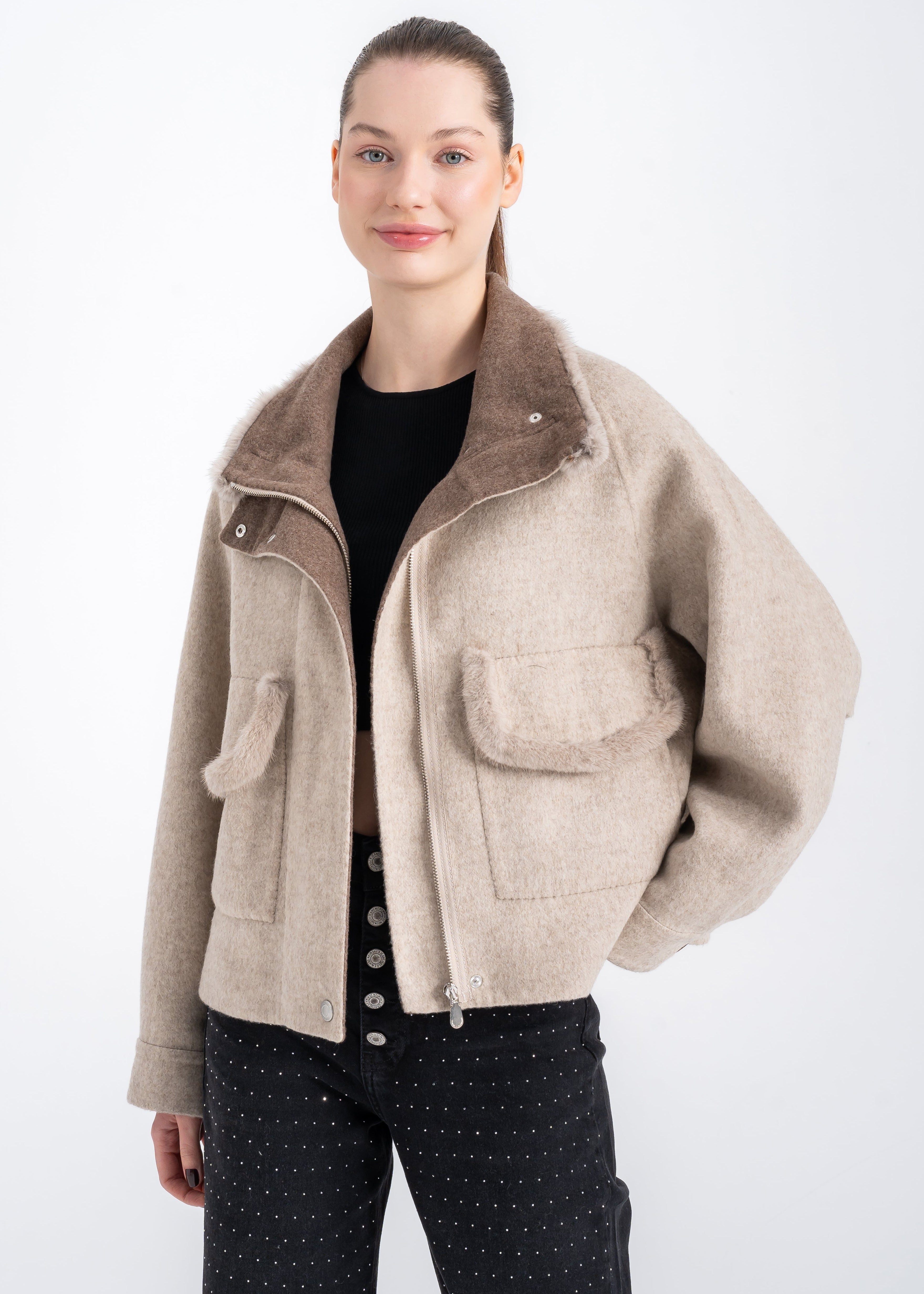 Woman wearing a beige alpaca wool jacket with mink trimmed collar and front patch pockets, relaxed hip length fit and front zipper closure by Lebeni.