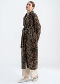 Model wearing a long leopard print shearling wrap coat with self tie belt by Lebeni.