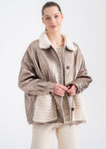 Woman wearing a champagne metallic shearling jacket with mink fur collar and mink detailed front pockets by Lebeni.