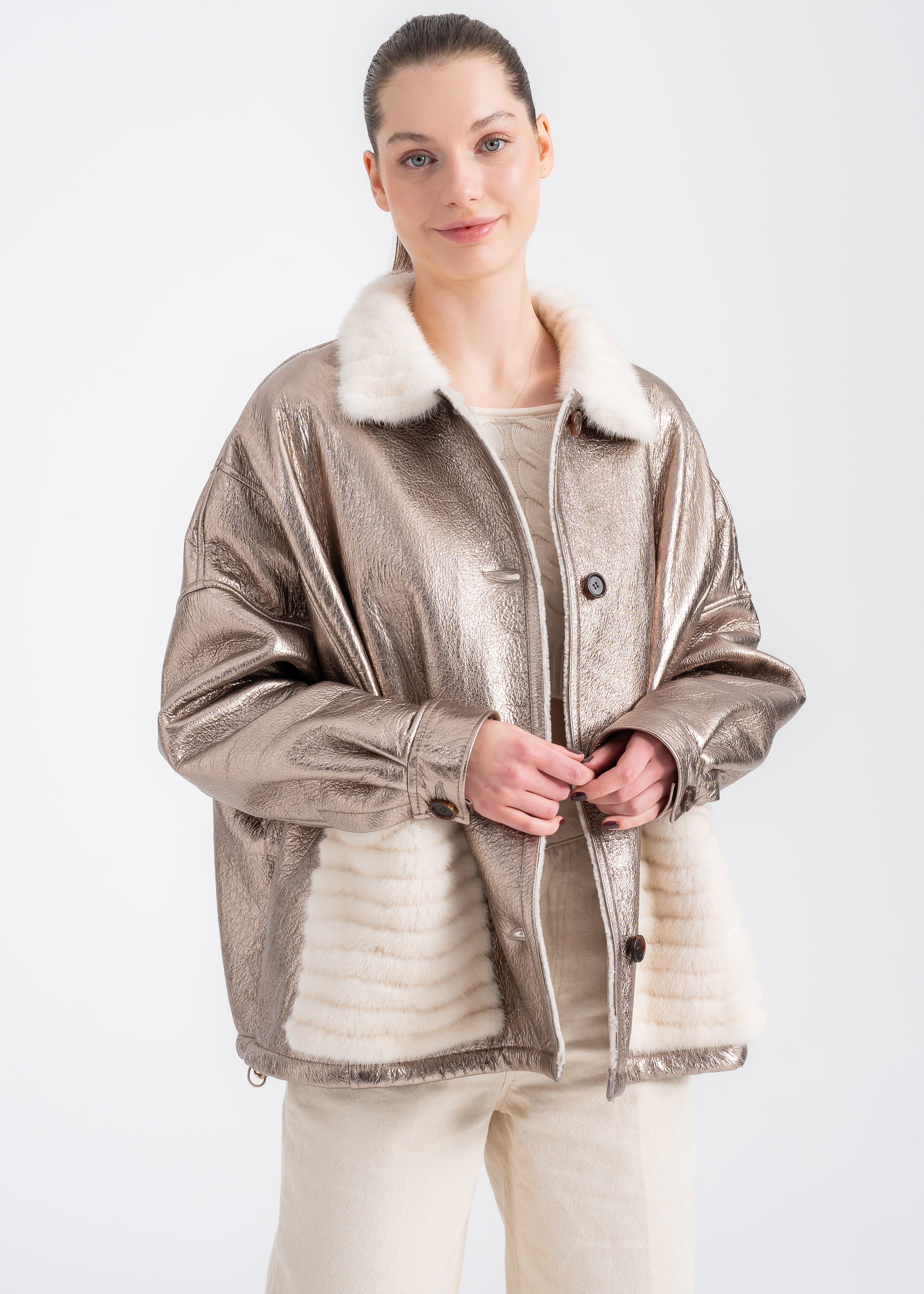 Woman wearing a champagne metallic shearling jacket with mink fur collar and mink detailed front pockets by Lebeni.