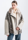 Woman wearing a light beige shearling front jacket with real fur collar and quilted panels by Lebeni.