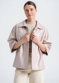 Model wearing a blush lambskin boxy jacket with open front, wide sleeves, and clean minimal design by Lebeni.