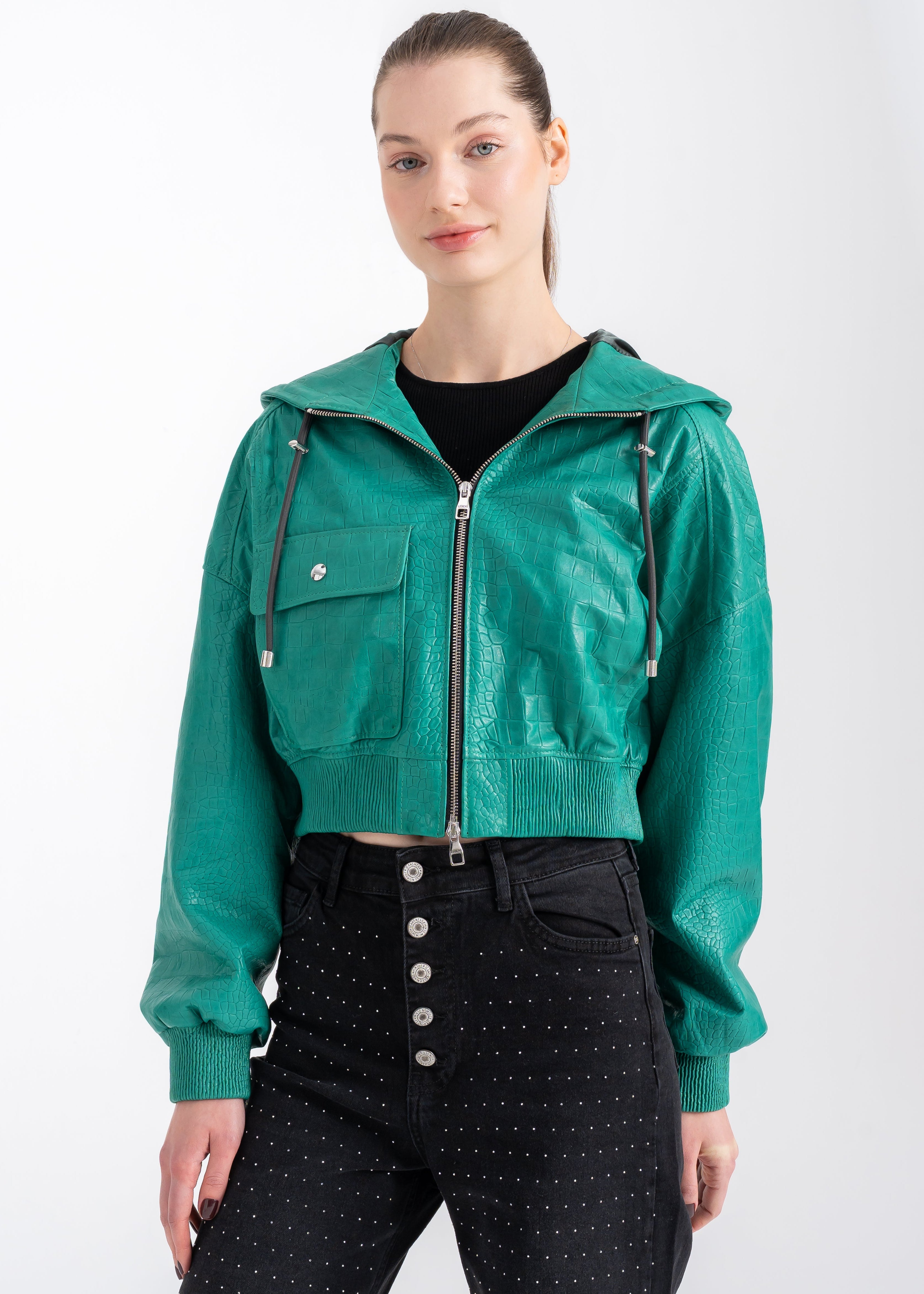 Model wearing an emerald green croc-embossed lambskin hooded jacket with front zipper, chest flap pocket, and ribbed hem by Lebeni.