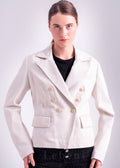 Woman wearing an ivory lamb leather blazer jacket with double breasted gold tone buttons, notched lapel collar and tailored fit by Lebeni.
