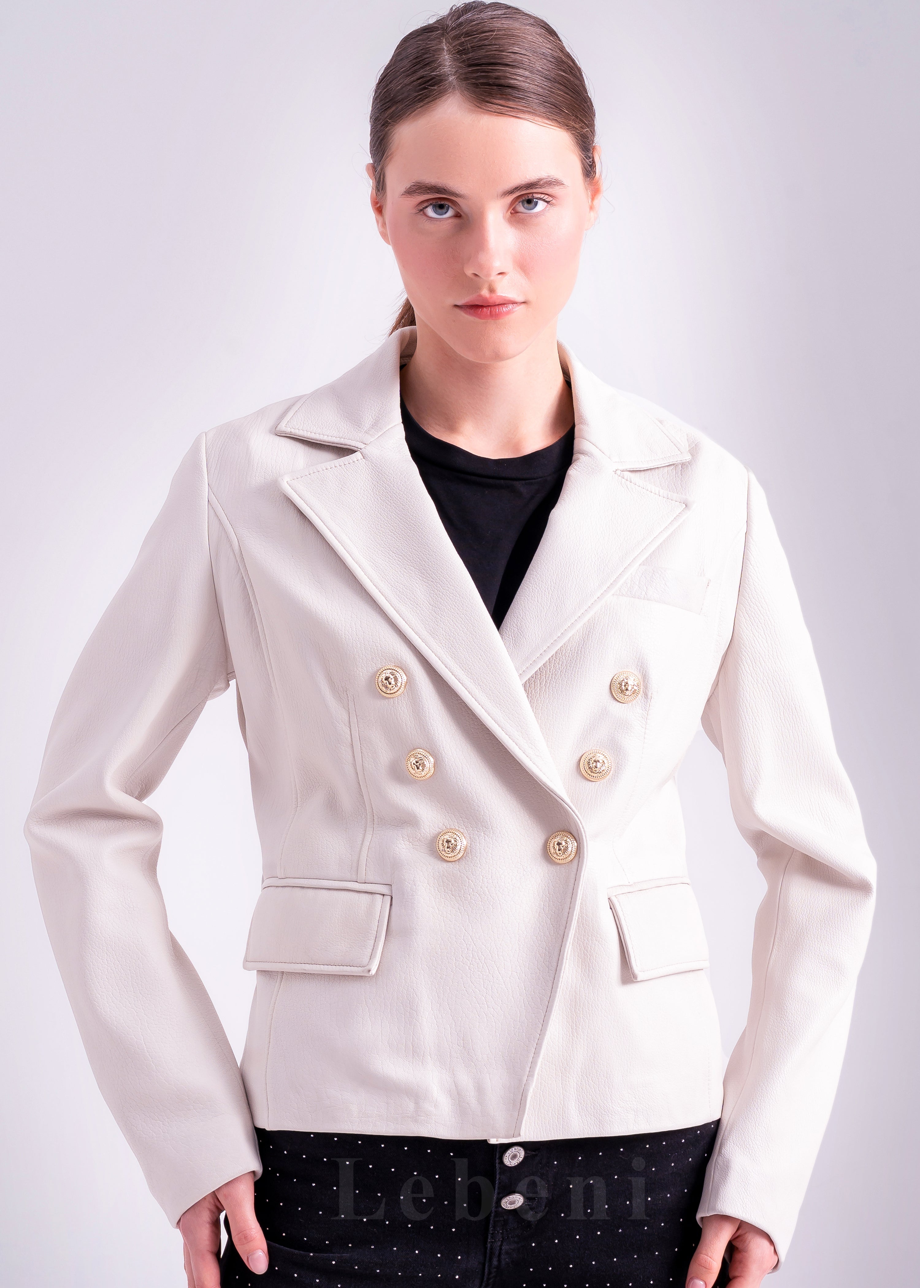 Woman wearing an ivory lamb leather blazer jacket with double breasted gold tone buttons, notched lapel collar and tailored fit by Lebeni.